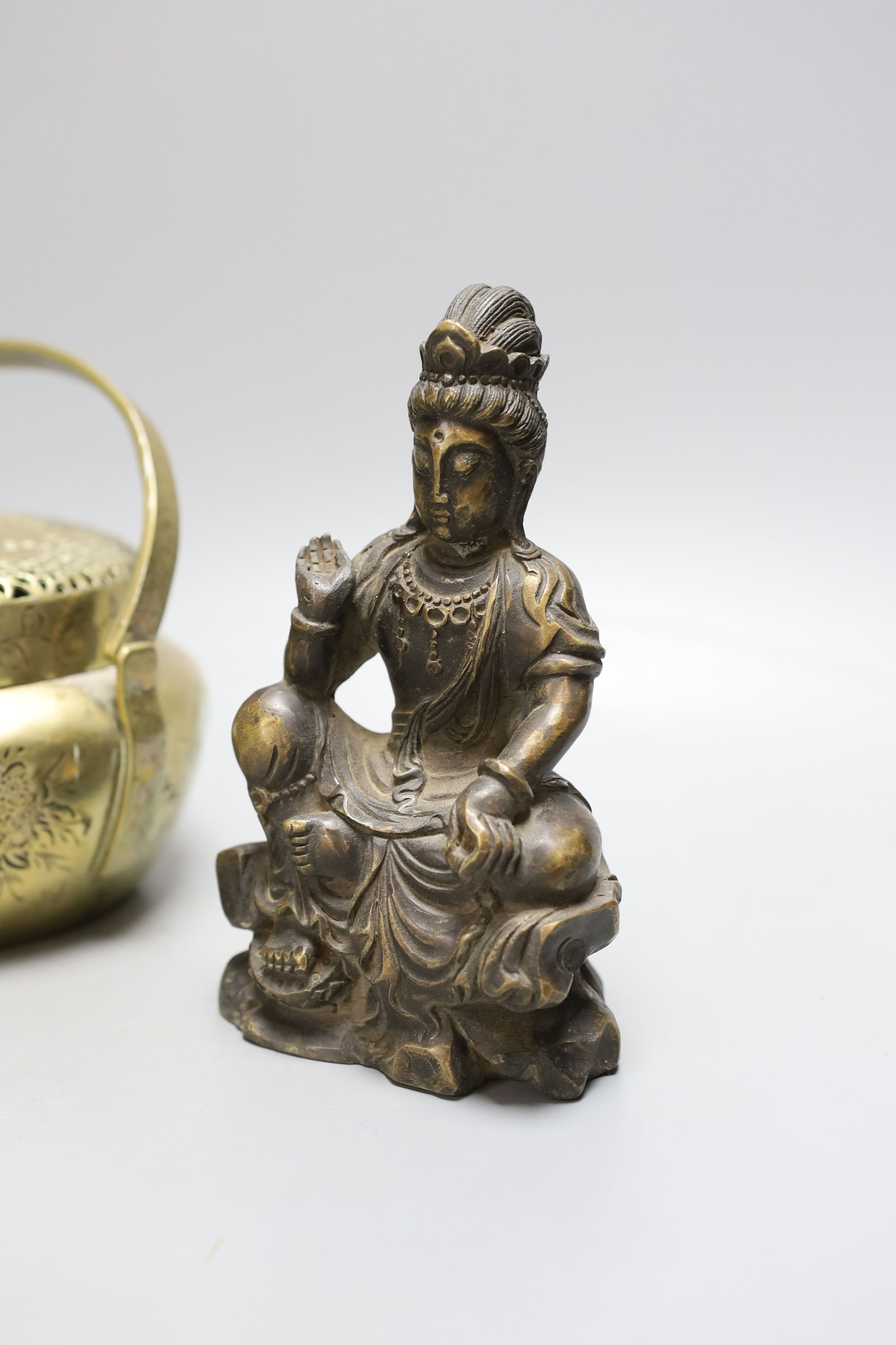 Two Chinese bronze hand warmers, one with Xuande mark, together with a seated Buddha, 16cm tall, (3)